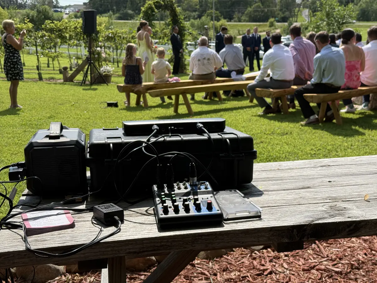 Outdoor wedding ceremony sound setup with battery-powered speakers providing clear audio for vows and processional music