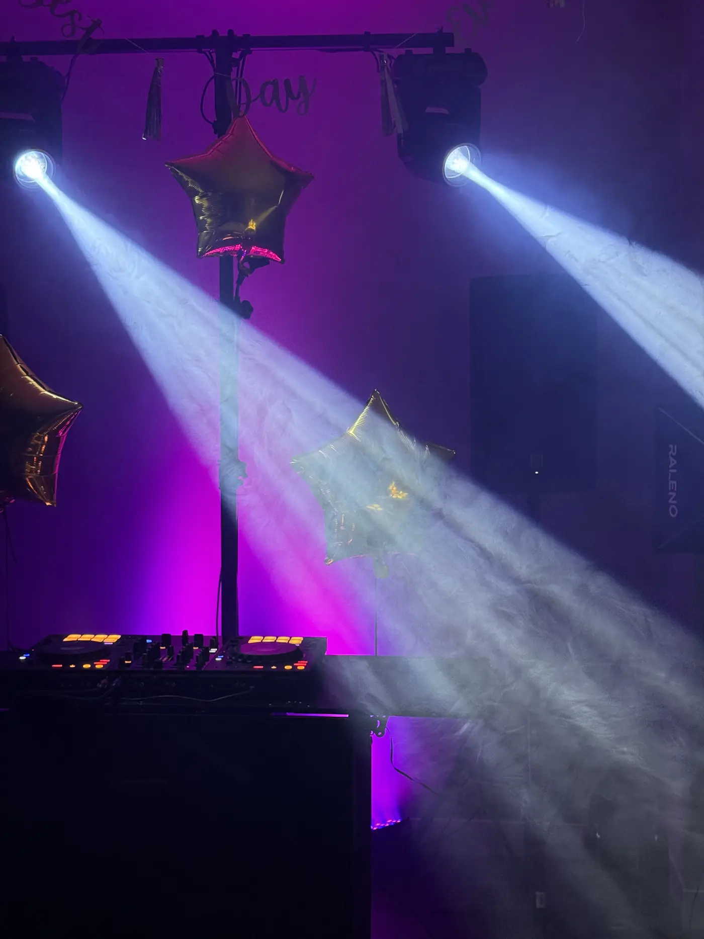 Two moving heads shooting visible beams through haze at a reception, demonstrating how haze makes light beams visible in the air