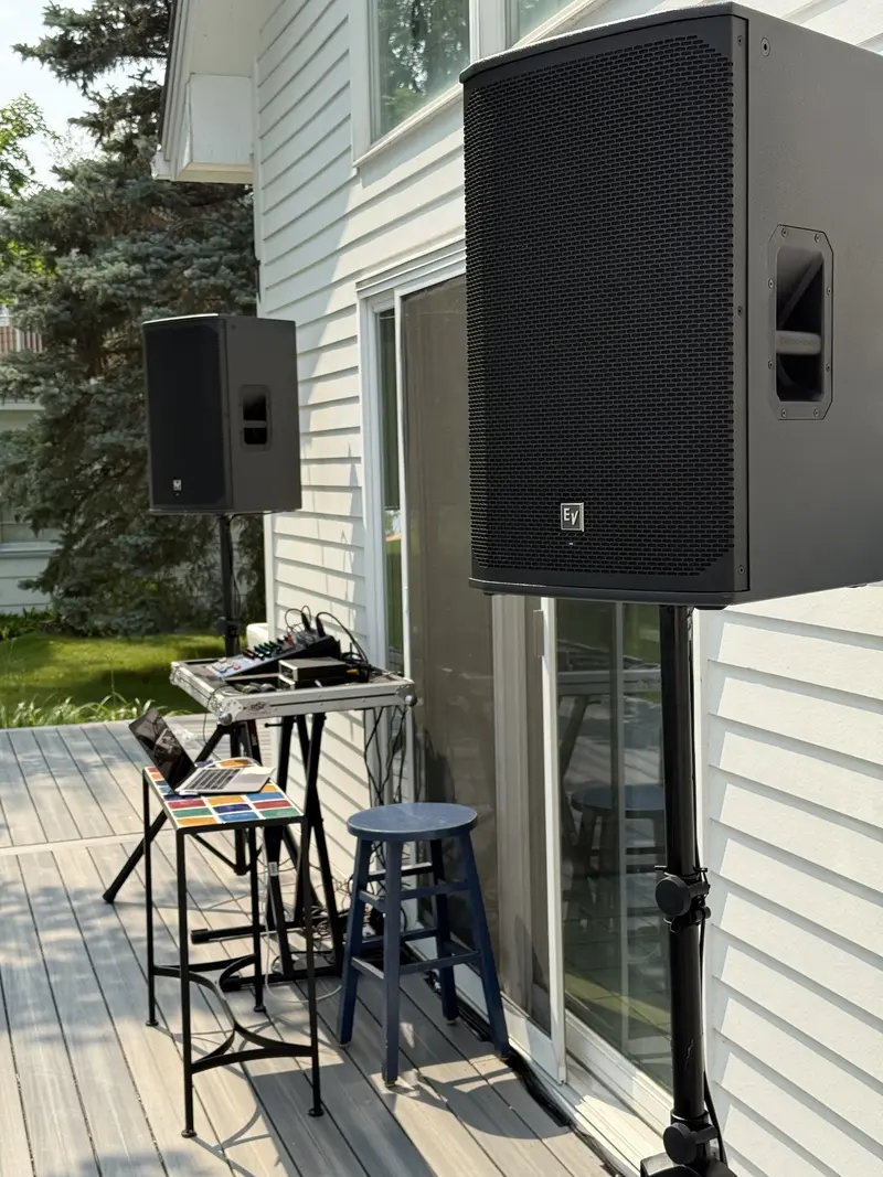 Outdoor speaker rental and DJ setup on a patio deck in Minnesota