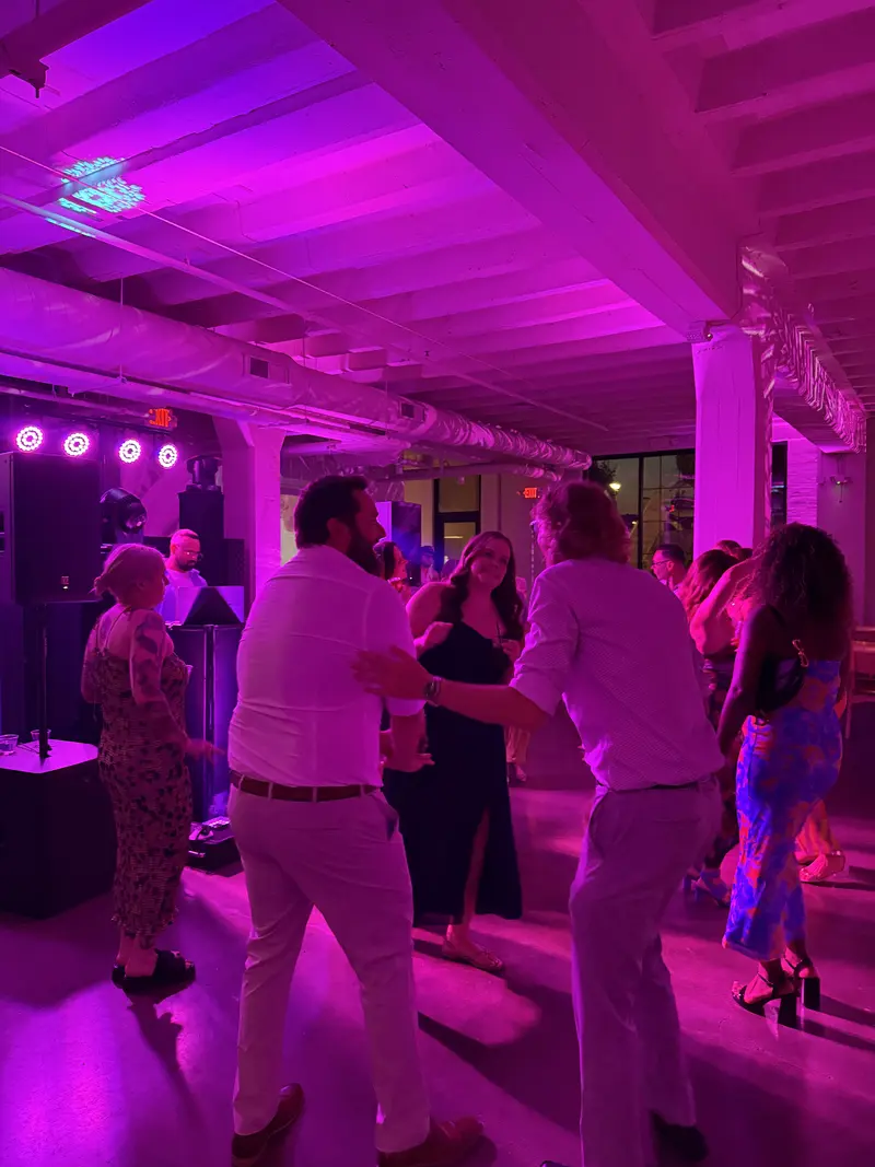 Wedding guests dancing with purple LED event lighting in Minneapolis