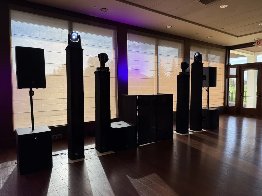 Wedding venue with uplighting, moving heads, speakers, and floral decorations