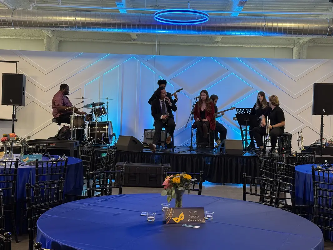 Luxury venue with speaker rental and sunset view through panoramic windows