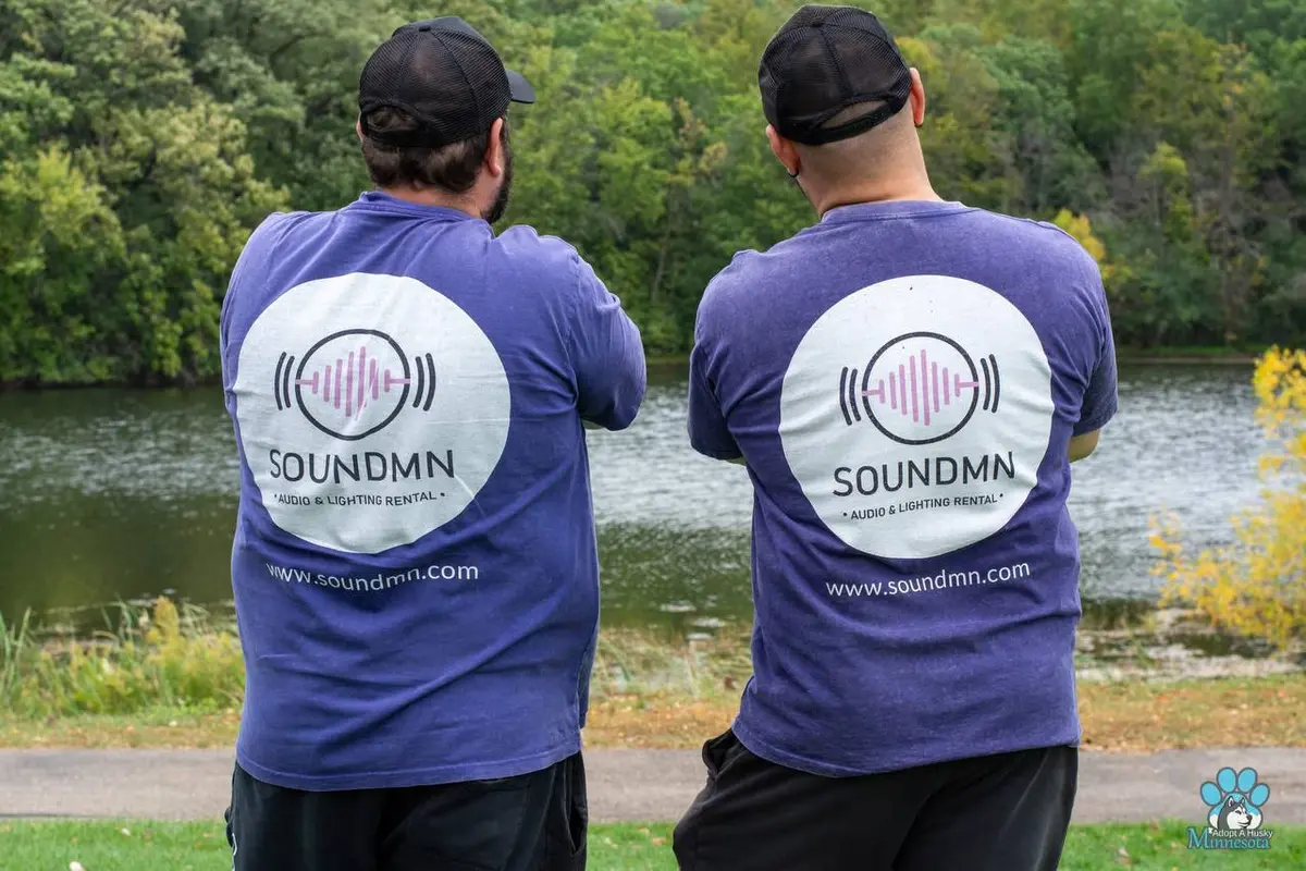 SoundMN team members in branded shirts by the lake in Minnesota