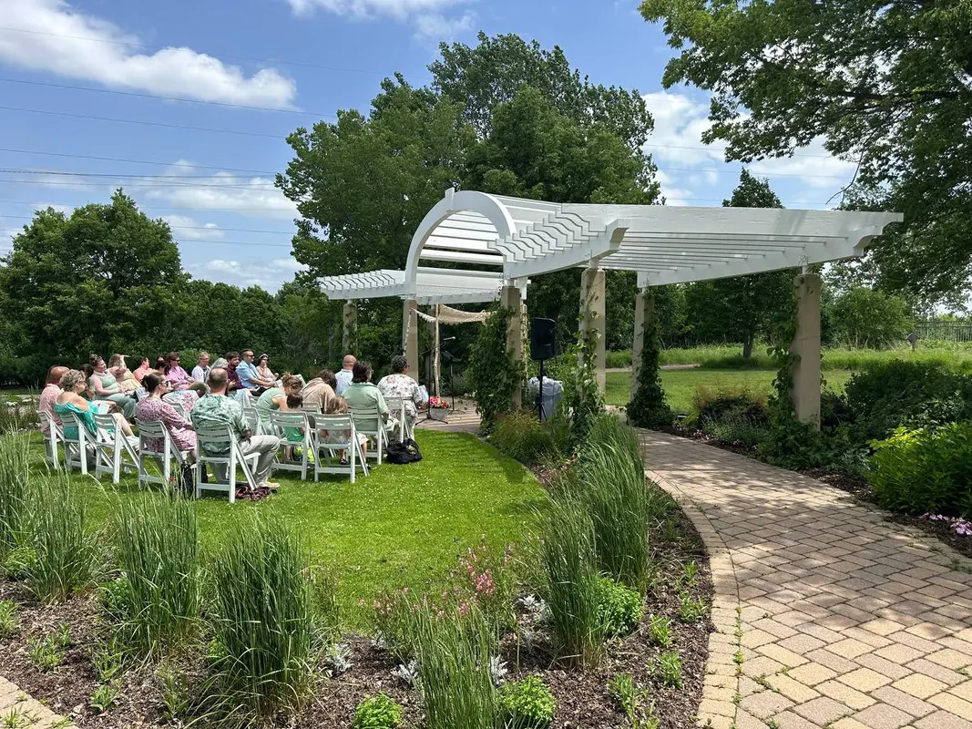 Outdoor wedding ceremony at a garden venue with speaker rental in Minnesota